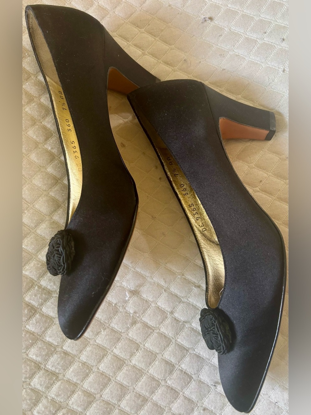 Classic Black satin Salvatore Ferragamo pumps featuring a braided knot detail